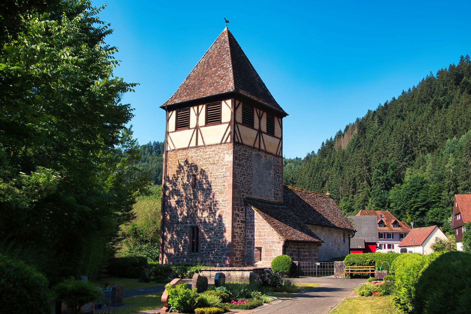 A picturesque view of an old church amidst lush greenery in Calw, Baden-Württemberg, Germany.