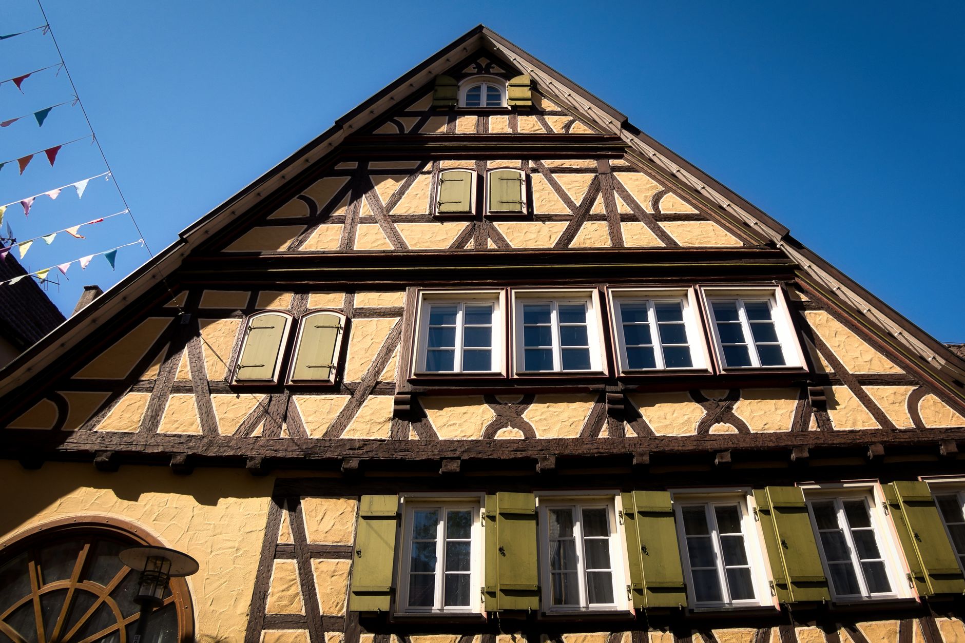Beautiful half-timbered house under clear blue sky in Calw, showcasing traditional German architecture.